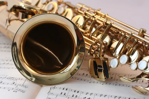Gold saxophone resting on music book